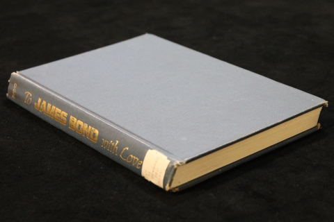 Side View of plain blue cover of To James Bond with Love with the title in gold lettering on the spine