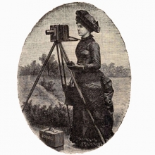 photo of a woman using a glass plate negative camera.