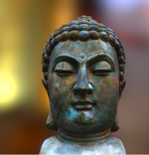 A small bronze sculpture of Buddha. 
