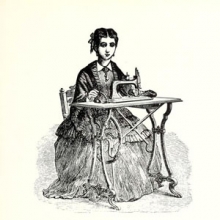 19th century woman sitting at a sewing machine