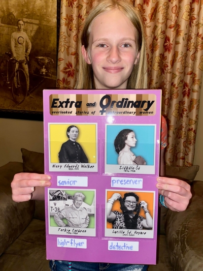 a young person holding their mock exhibit which includes Mary Edwards Walker, Zitkala-Sa, Jackie Cochran, and Lucille St. Hoyme